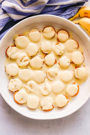 Nilla wafers, sliced bananas and custard poured over top in a round white casserole dish