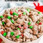 Reindeer chow mix in a large white bowl with Christmas ribbon laying nearby and a text overlay on the photo