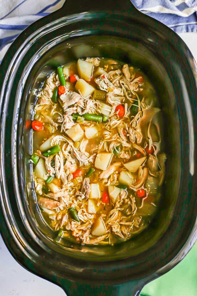 Chicken stew with potatoes, carrots and green beans in a slow cooker