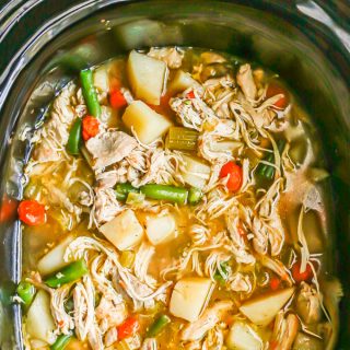 Hearty chicken stew with potatoes and green beans in a slow cooker