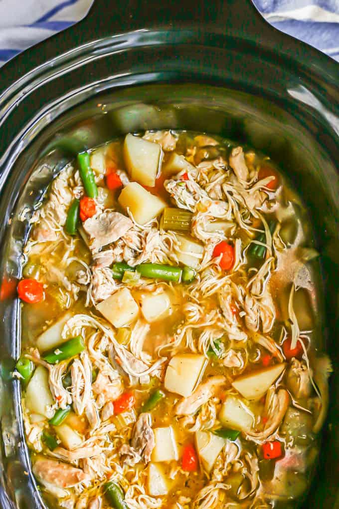 Hearty chicken stew with potatoes and green beans in a slow cooker