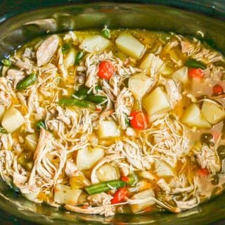 Chicken stew with potatoes, carrots and green beans in a crock pot