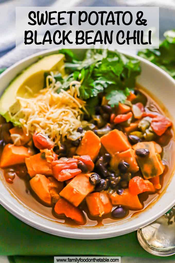 A low white bowl of sweet potato and black bean chili with toppings and a text overlay on the photo