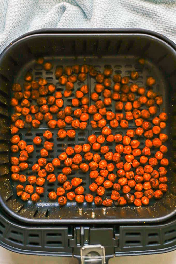 Seasoned and cooked, crispy chickpeas in an Air Fryer tray
