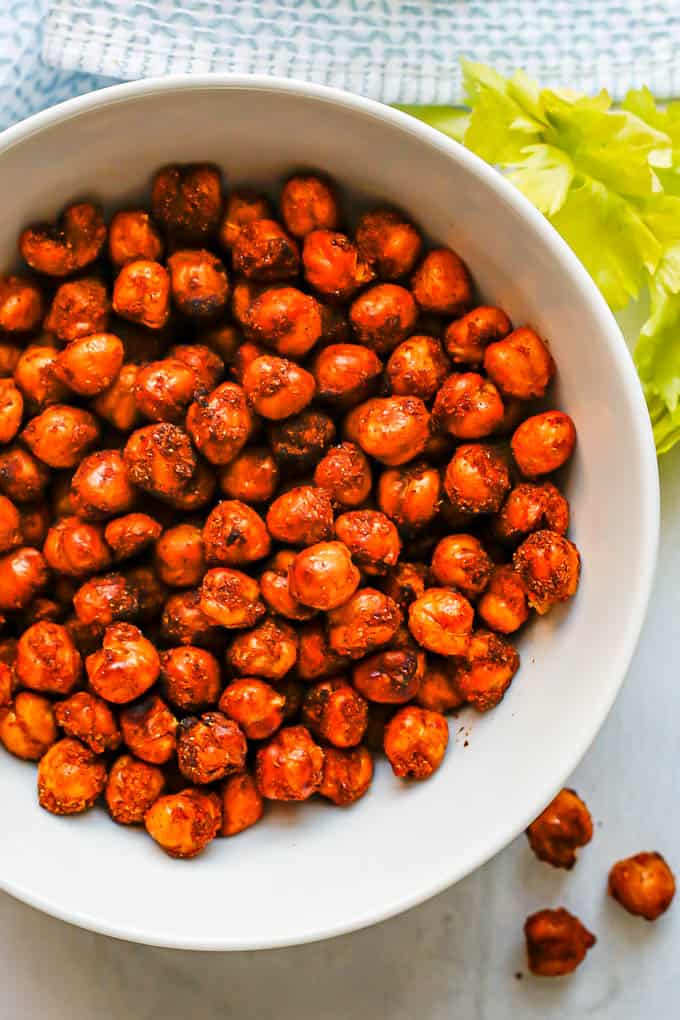Close up of seasoned and cooked chickpeas in a white bowl