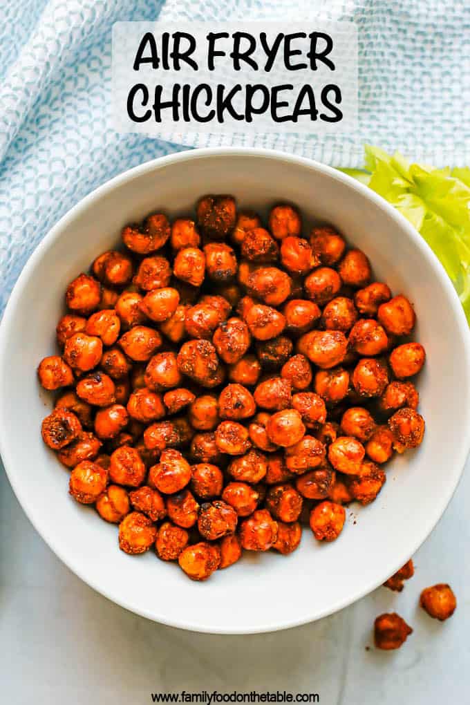 A small white bowl with seasoned and cooked Air Fryer chickpeas and a text overlay on the photo