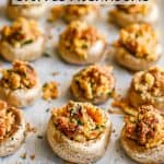Close up of a stuffed mushroom on a baking sheet lined with parchment paper with a text overlay on the photo