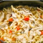 A ladle of chicken noodle soup being lifted from a slow cooker with a text overlay on the photo