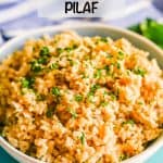 Brown rice pilaf served in a large white bowl with parsley on top and a text overlay on the photo