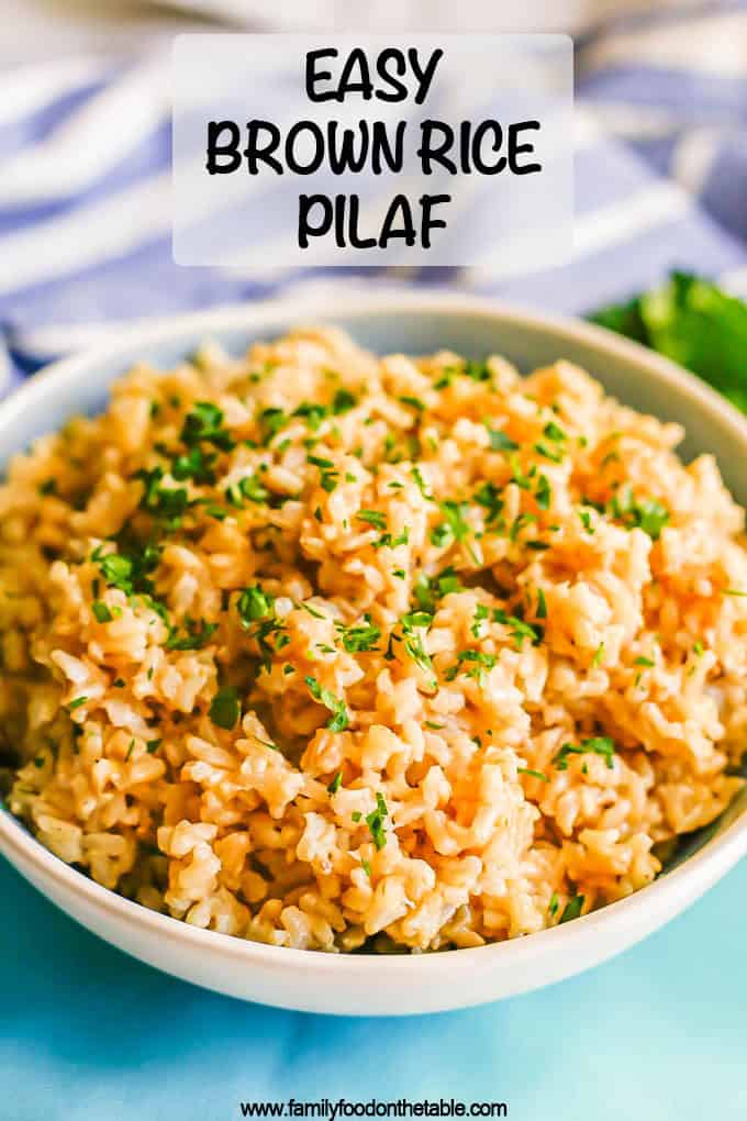 Brown rice pilaf served in a large white bowl with parsley on top and a text overlay on the photo