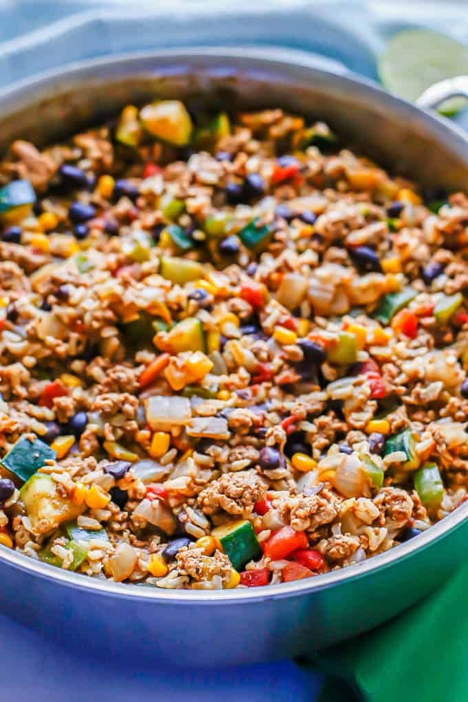 Close up of a ground turkey skillet with rice, beans, corn, tomatoes and veggies