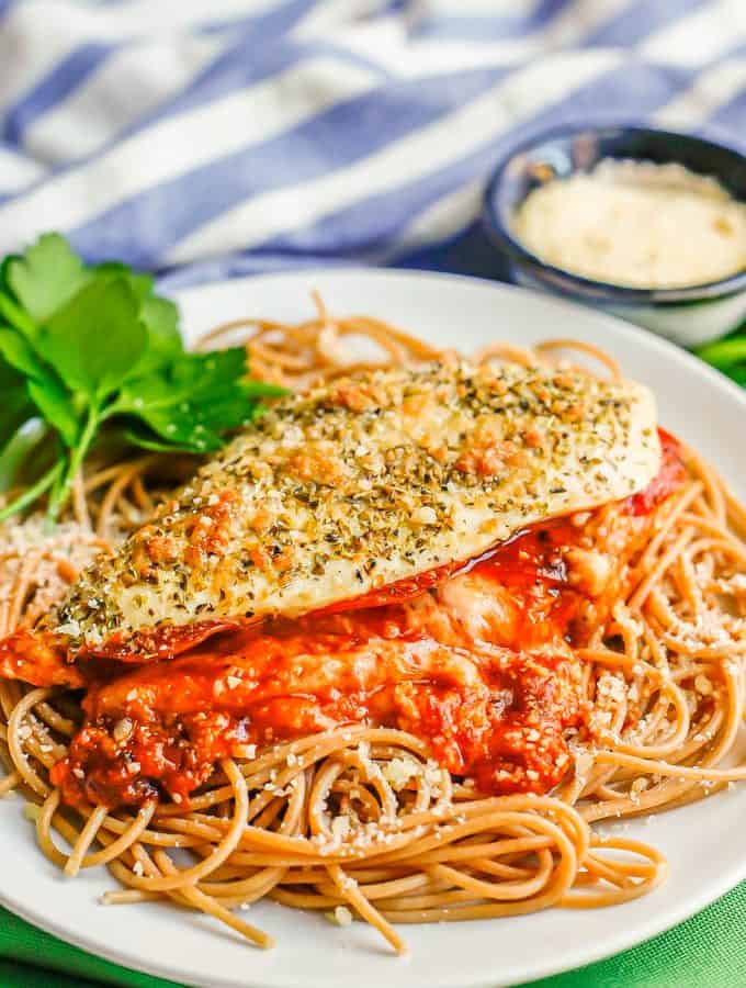Pizza stuffed chicken breasts with marinara and melty mozzarella cheese on a bed of spaghetti