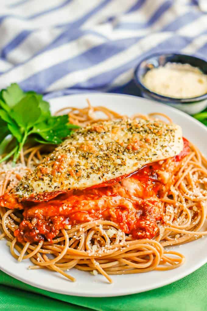 Pizza stuffed chicken breasts with marinara and melty mozzarella cheese on a bed of spaghetti