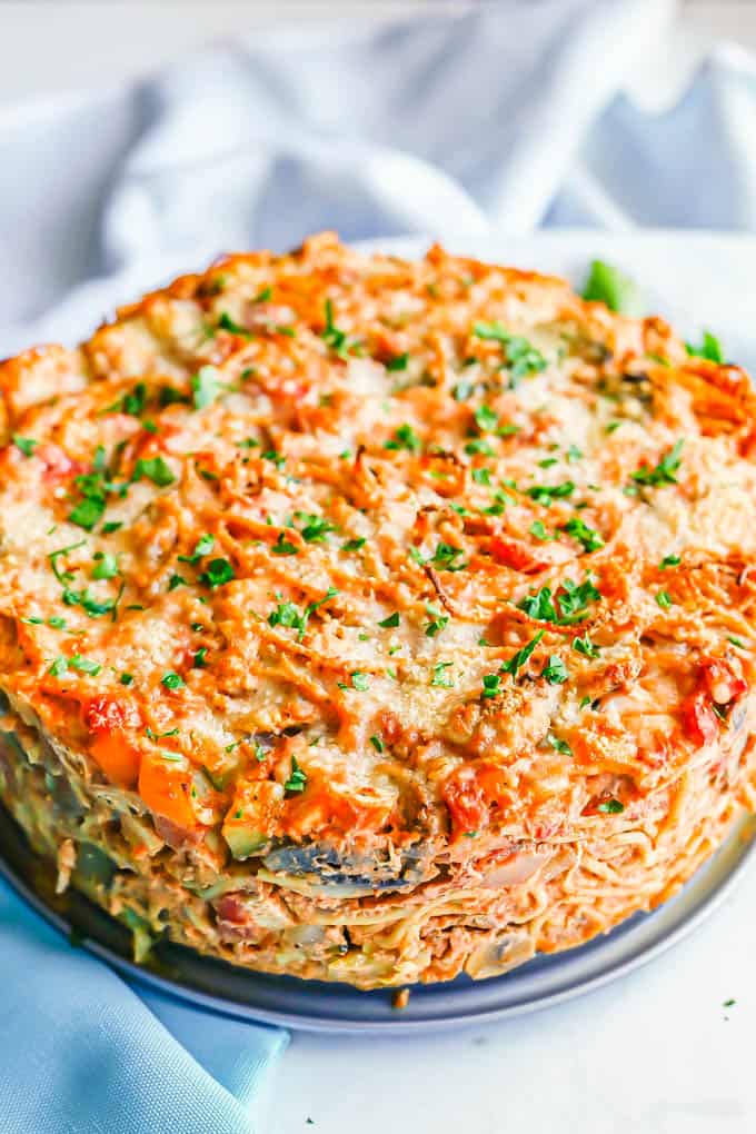 A thick baked spaghetti pie with chicken and vegetables