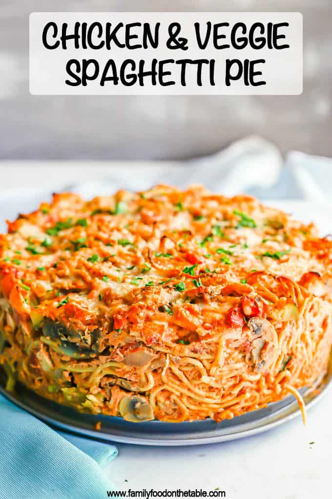 Side view of a thick baked chicken and veggie spaghetti pie with a text overlay on the photo