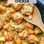 A skillet with saucy honey mustard chicken with onions and a wooden spoon scooping some up with a text overlay on the photo