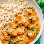 Instant Pot butter chicken served with rice in a low white bowl with a text overlay on the photo