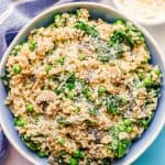 A mix of brown rice and veggies with Parmesan cheese served in a blue and white bowl with a text overlay on the photo