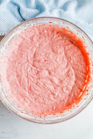 Strawberry cheesecake filling in a large glass bowl