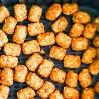 Crispy golden brown tater tots in an Air Fryer tray after cooking