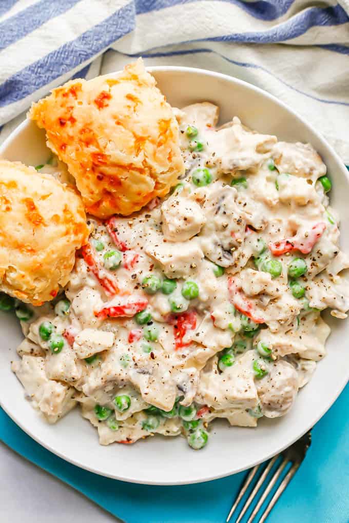 Chicken a la King served with two cheesy biscuits in a low white bowl