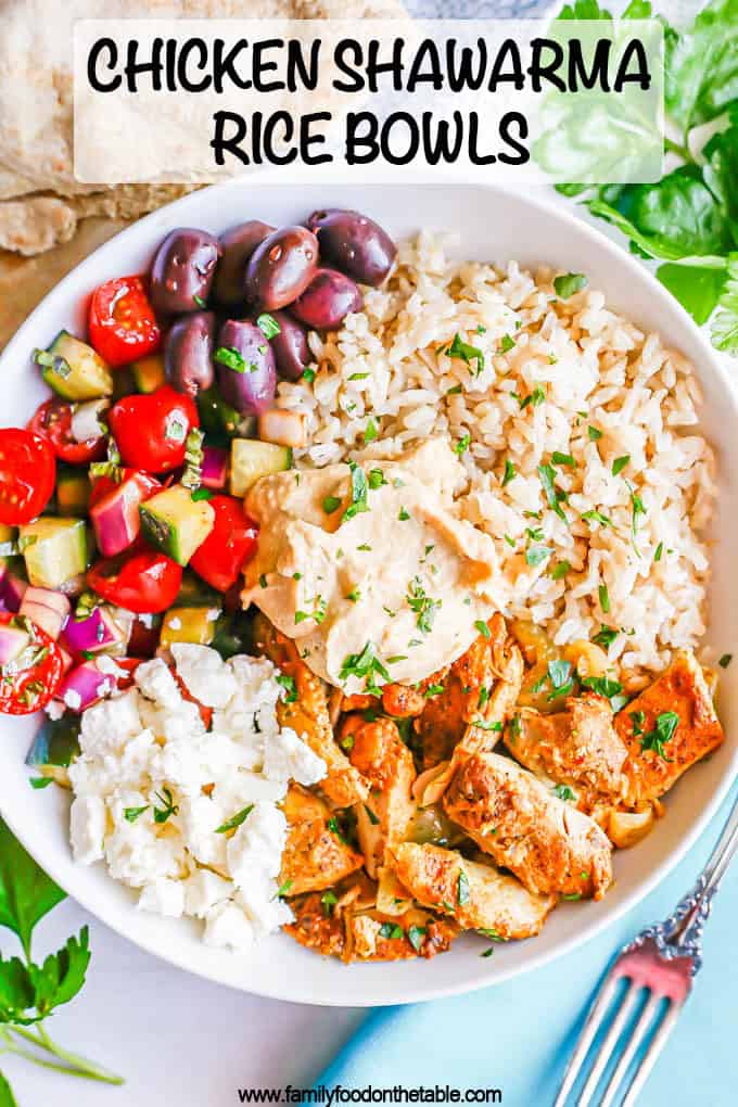A low white bowl with brown rice, chicken shawarma, fresh veggies, olives, feta and hummus with a text overlay on the photo