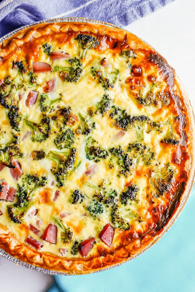 Close up of a ham and broccoli quiche in a golden brown pie crust after baking