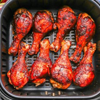 An Air Fryer tray with BBQ chicken drumsticks after cooking