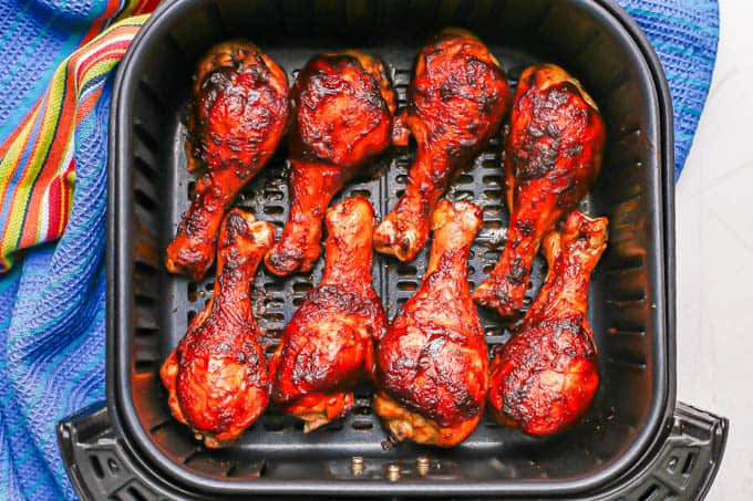 An Air Fryer tray with BBQ chicken drumsticks after cooking