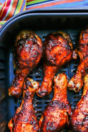 Close up of BBQ basted chicken legs in an Air Fryer after cooking