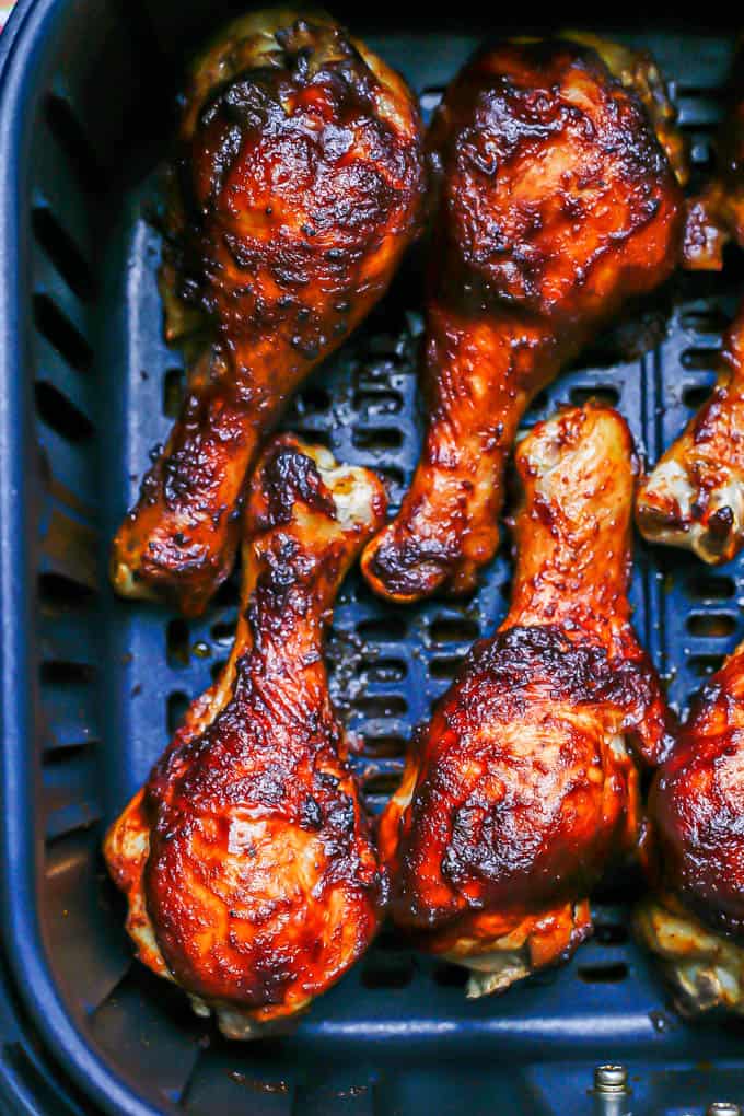 Sticky BBQ chicken legs in an Air Fryer tray after cooking