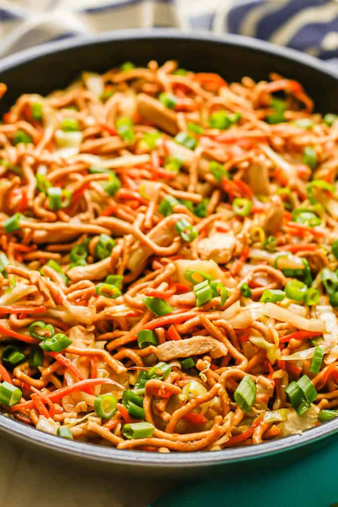 Chicken chow mein with chicken, cabbage, carrots and crispy chow mein noodles in a large skillet