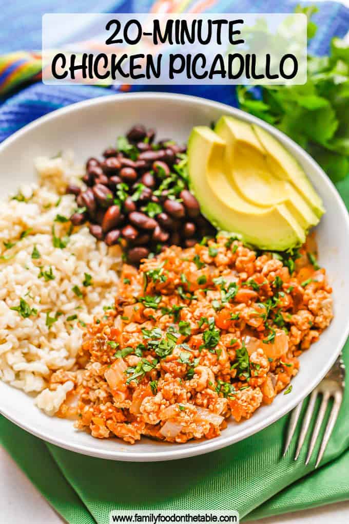 Low white bowl with chicken picadillo topped with cilantro served with rice, black beans and avocado with a text overlay on the photo