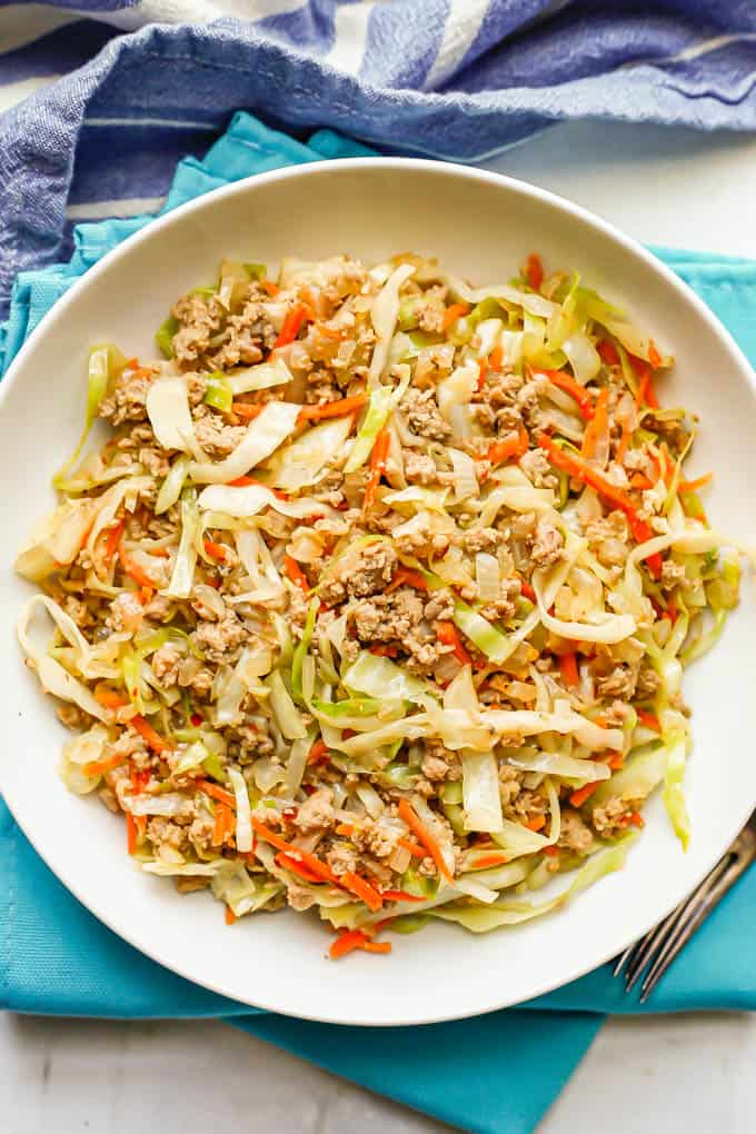 A mixture of ground turkey, cabbage and carrots served in a low white bowl