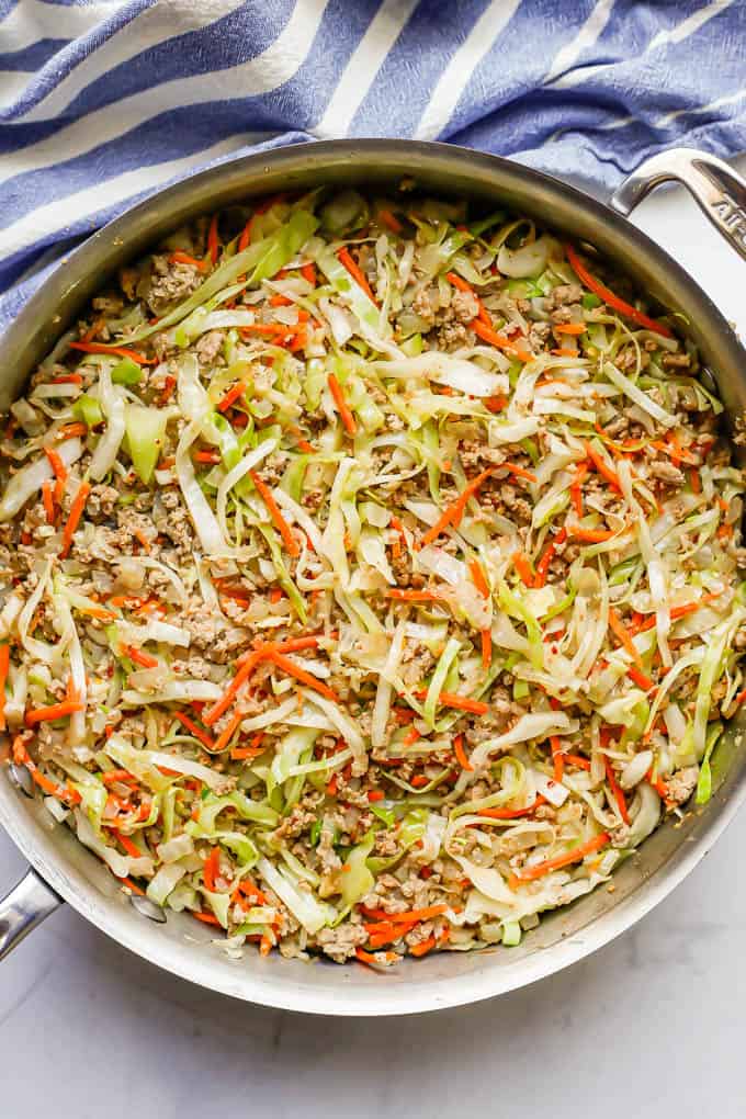An egg roll mixture of ground turkey, cabbage and carrots all cooked together in a large skillet