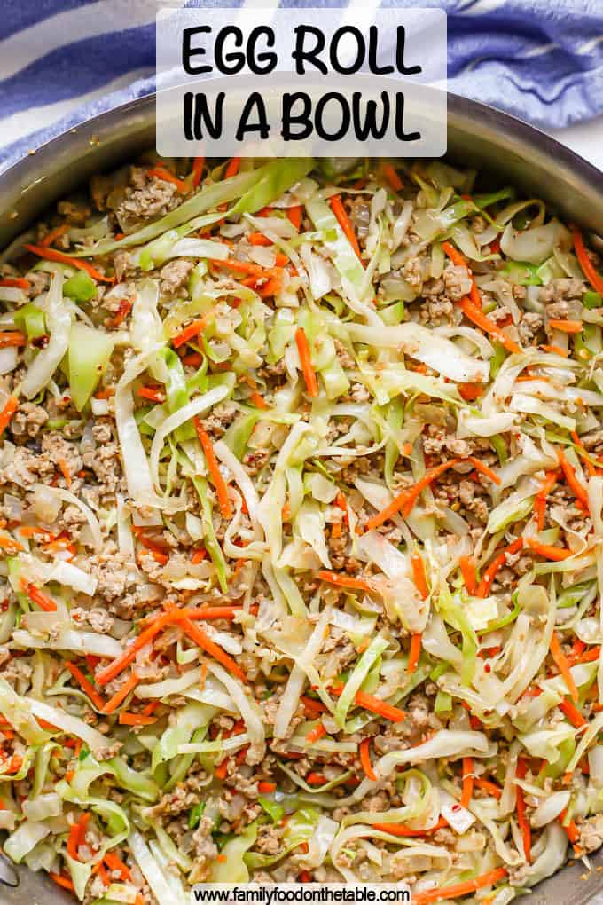 A large deep skillet with an egg roll mixture with ground turkey, cabbage and carrots and a text overlay on the photo