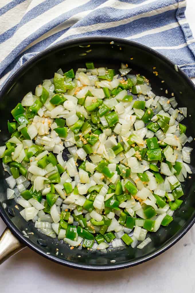 Sautéed onions and green bell pepper in a large skillet