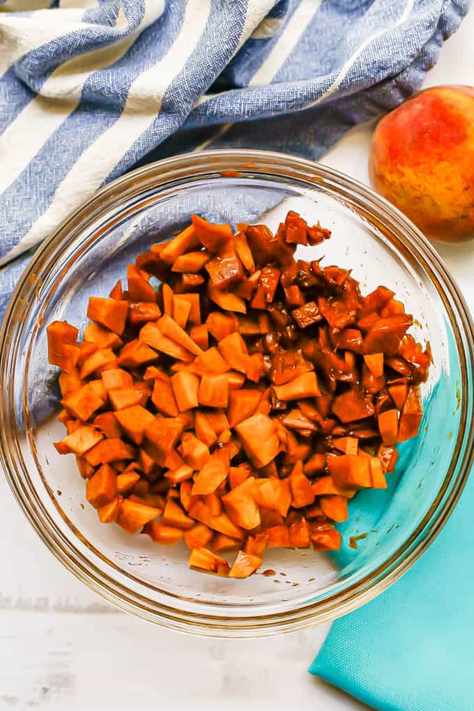 Diced and partially mashed peaches in a glass bowl