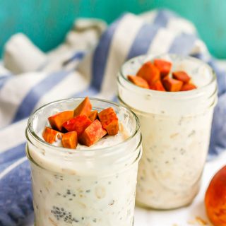 Two small glass jars of peach overnight oats with extra peaches on top