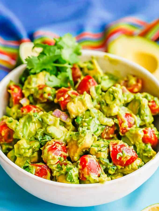 Avocado salad with tomatoes in a large white bowl