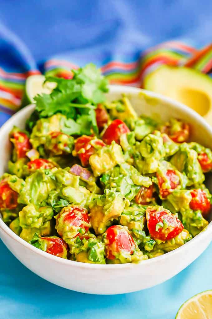 Avocado salad with tomatoes in a large white bowl