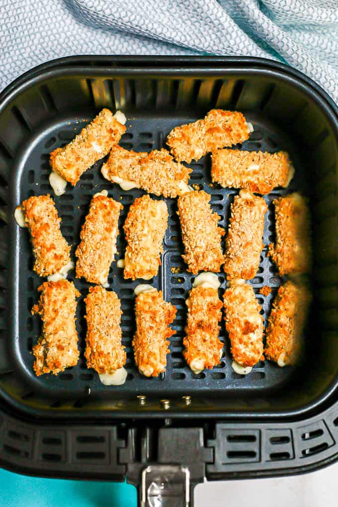Air Fryer mozzarella sticks in the insert after cooking