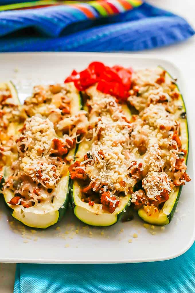 Stuffed zucchini with turkey sausage and cheese served on a white plate