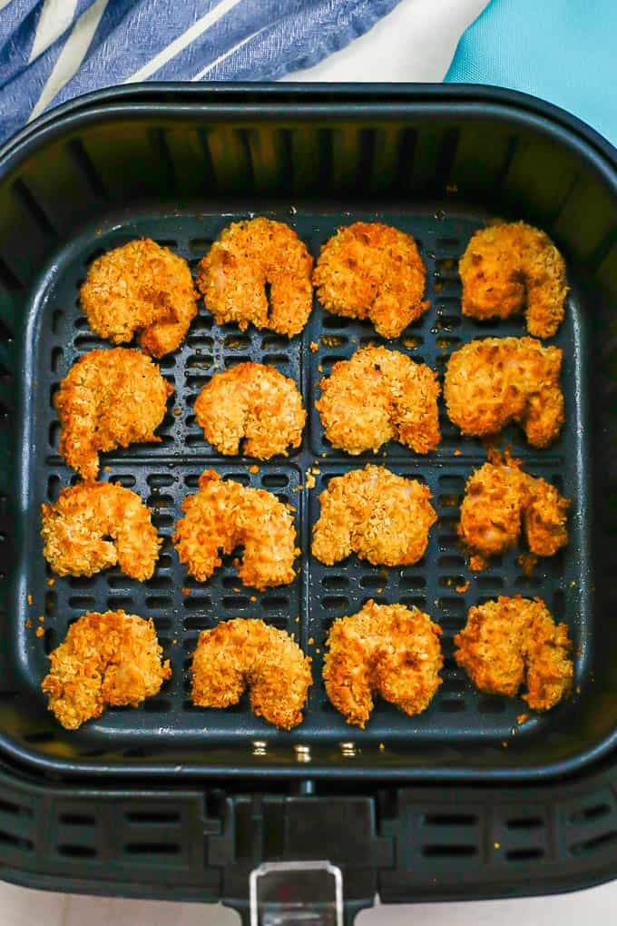 Golden brown crispy cooked shrimp in an Air Fryer tray