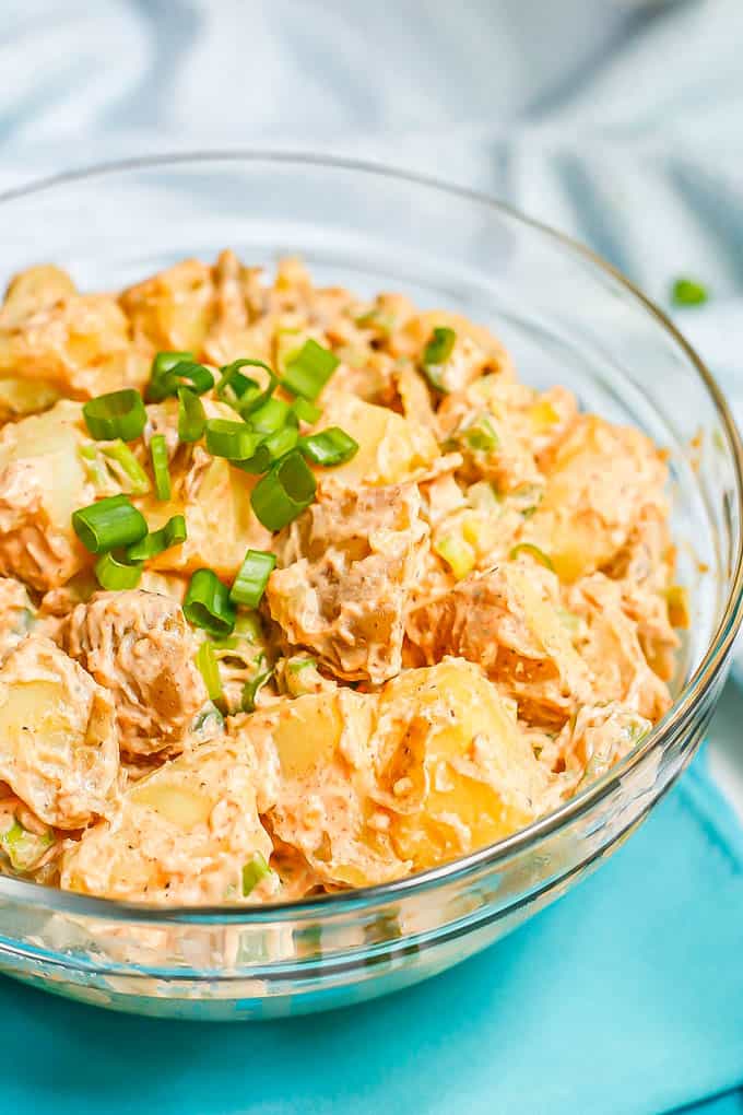 Creamy potato salad in a large glass serving bowl