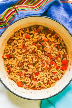 A large Dutch oven with a ground turkey pasta mixture with tomatoes and vegetables