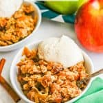A spoon resting in a bowl of vanilla ice cream topped apple crisp with a text overlay on the photo
