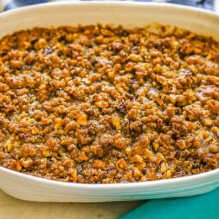 Baked sweet potato casserole with a pecan streusel in a white baking dish