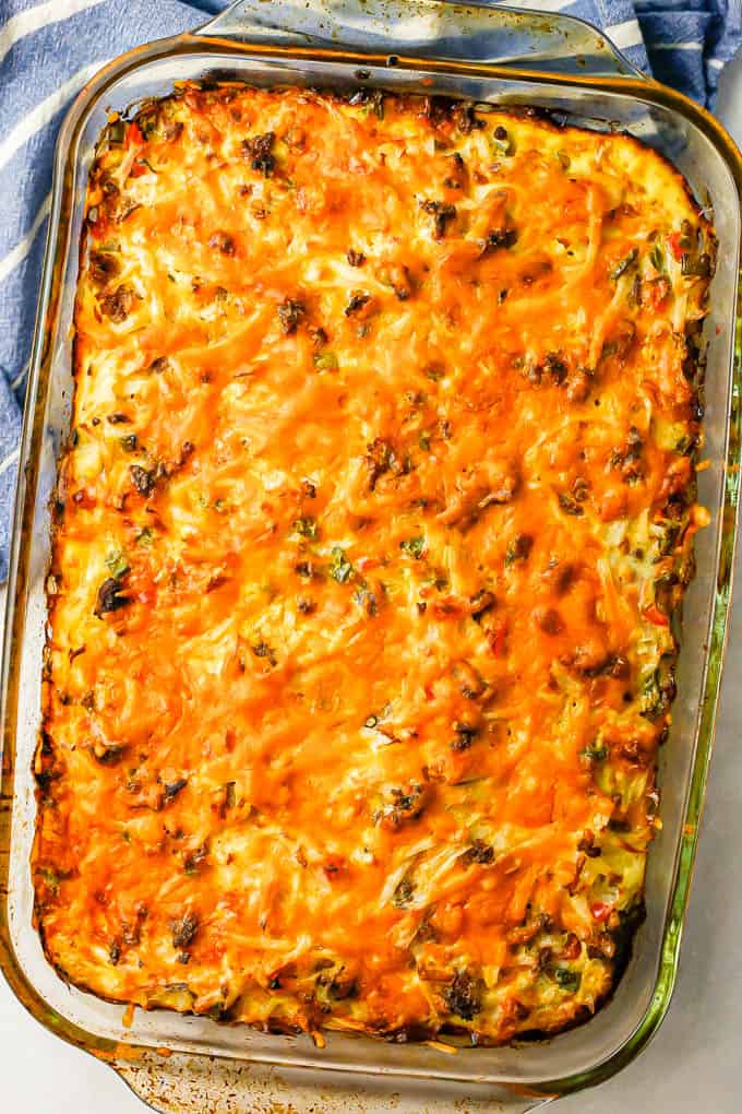 A cheesy hash brown casserole in a large baking dish after coming out of the oven