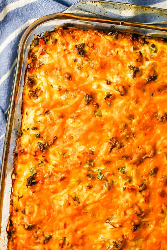 Close up of a cheesy baked hash brown breakfast casserole in a baking dish